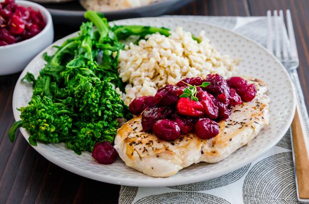 Plate of Maple Cranberry Chicken with sides of broccolini and rice