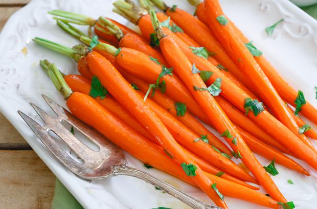 Platter of whole maple glazed carrots with green tops