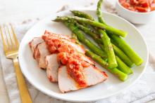 Grilled Pork Tenderloin with Rhubarb Barbecue Sauce plated with steamed asparagus