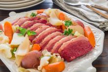 Platter with sliced corned beef and cabbage